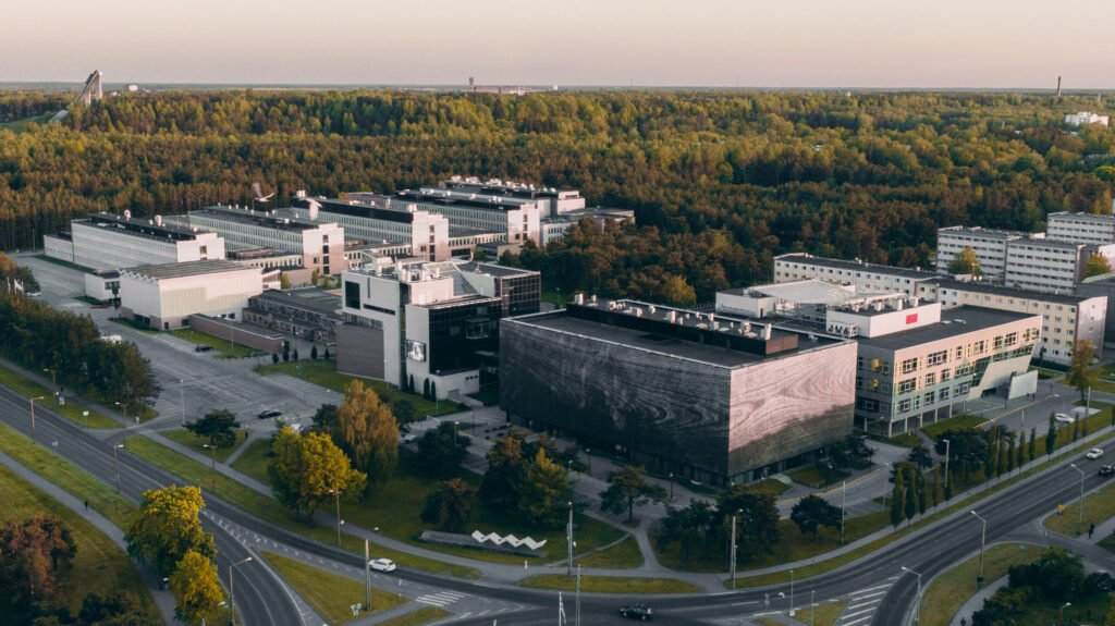 alt="Aerial view of TalTech campus surrounded by greenery"